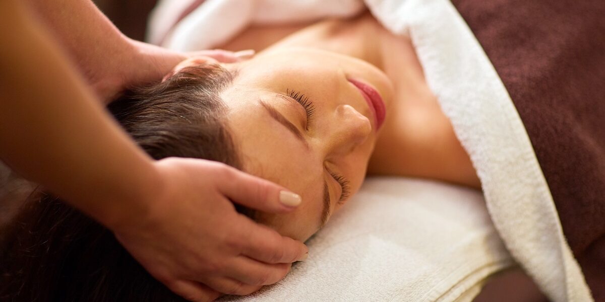 woman having head massage at spa